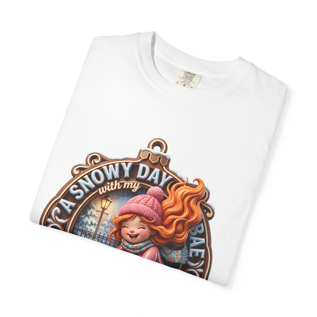 Folded white t-shirt showing the top of the A Snowy Day With My Bae badge print