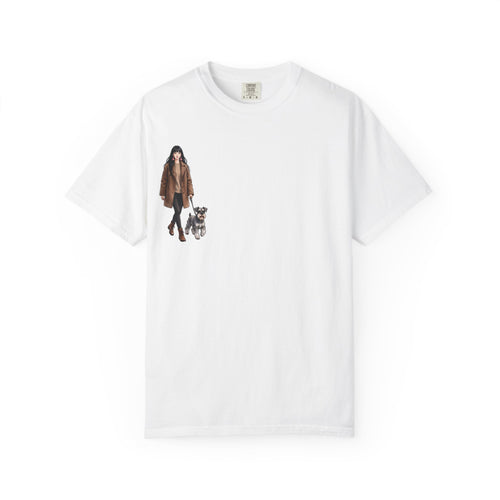 White t-shirt with a small chest print of a woman in a camel coat walking her grey schnauzer
